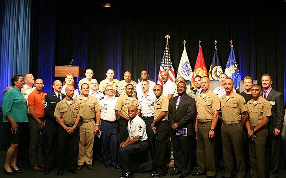 Servicemembers pose for a group photo Tuesday at the Pentagon&#39;s gay, lesbian, bisexual and transgender Pride Month celebration.