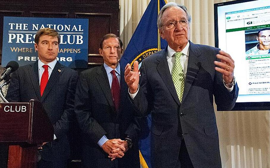 Sen. Tom Harkin, D-Iowa, answers a question during a press conference Wednesday at the National Press Club in Washington, D.C. Behind him are Kentucky Atty. Gen. Jack Conway, left, and Sen. Richard Blumenthal, D-Conn. At right is a view of the GIBill.com website, which will be turned over to the Department of Veterans Affairs after a consumer protection settlement.