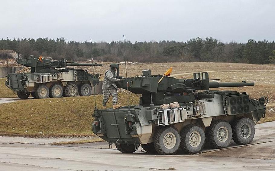 A soldier with the 2nd Cavalry Regiment circles the turret of an MGS variant Stryker armored vehicle during a live-fire exercise at the Grafenwöhr Training Area.