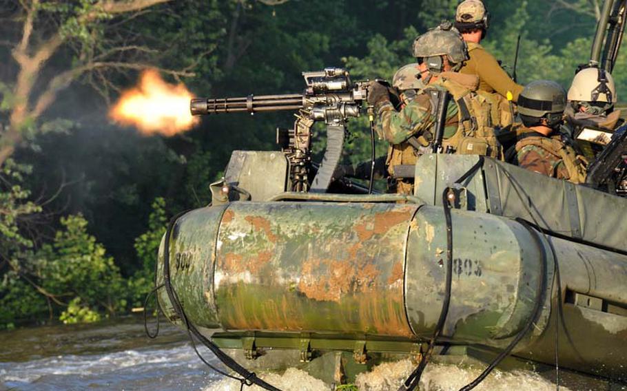 Seaman Edward Brand, a gunner's mate assigned to Riverine Squadron 1, fires a GAU-17A gun system from the bow of a riverine patrol boat during a live-fire exercise on May 8, 2012, in Knox, Ky. 