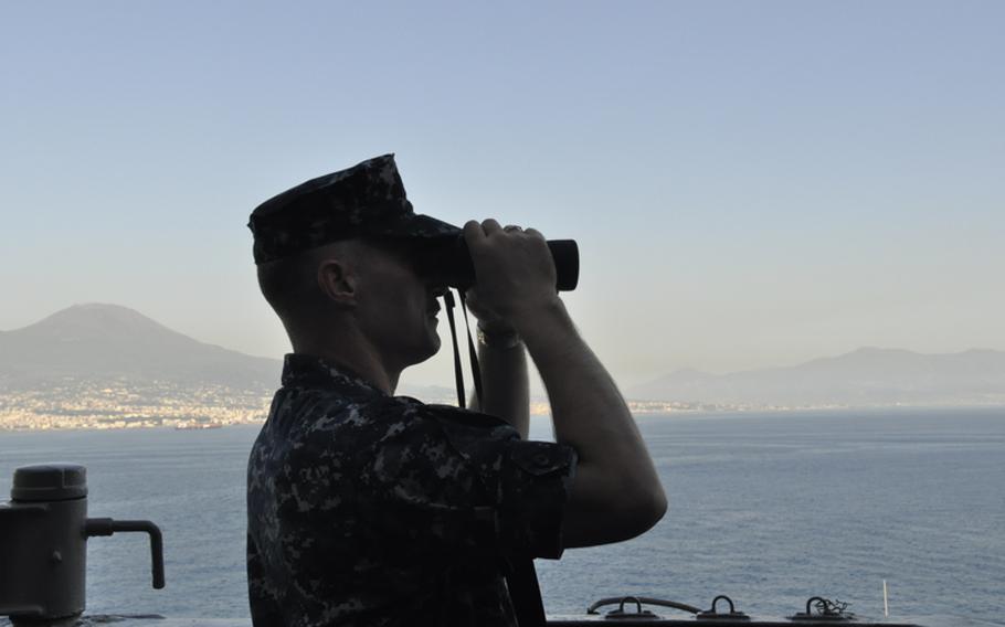 Lt. Tracy Mackey looks out toward the Gulf of Naples from the flight deck control tower onboard the USS Enterprise. Mackey said he was eager to get home to Iowa after seven months on the ship. The Enterprise’s 25th deployment is its last after 50 years of service.