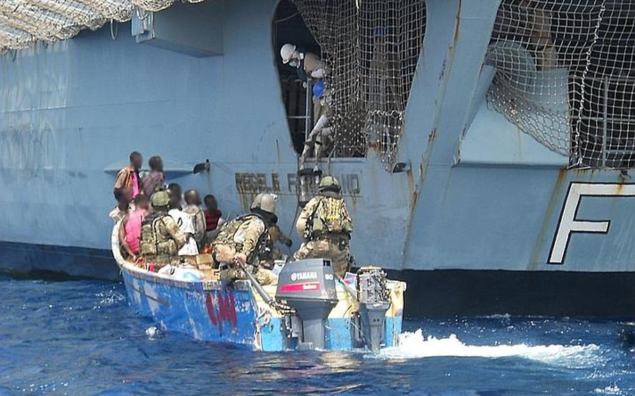 A boarding team from the Romanian frigate ROS Regele Ferdinand brings a group of suspected pirates and their skiff back to the Romanian warship. The suspects were apprehended off the coast of Somalia on Wednesday. They were released Thursday when European Union legal advisers determined it would be difficult to prosecute them.

Photo courtesy European Union Naval Force