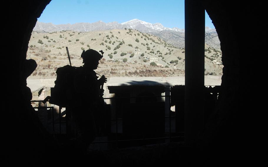 A U.S. soldier walks past a window outside an abandoned residence during a December clearance operation in the village of Haki Kalay, Khost province. The residence was said to be a former home of Jalaluddin Haqqani, leader of the Pakistan-based insurgent network that bears his name and is aligned with the Taliban.