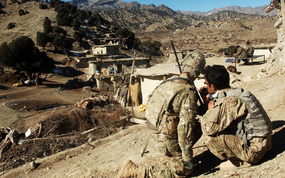 An interpreter, right, leans into the radio of 1st Lt. Raphael Moyer, a platoon leader from A Troop, 1st Squadron, 33rd Cavalry Regiment, during a December clearance operation with Afghan forces in the village of Haki Kalay, Khost province. The Afghan soldier on the other end of the conversation was also using a U.S. radio strapped to a soldier. The radios used by the Afghan soldiers had proven unreliable in the mountainous terrain, one of many deficiencies that made complex operations difficult for that unit and others.

Steven Beardsley/Stars and Stripes