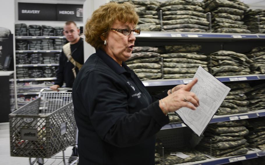 Karen Ringrose, a sales associate, helps Spc. Gage Schumacher, a wounded warrior, find the items he&#39;s looking for Wednesday, Jan. 16, 2013, after the grand opening of the Wounded Heroes Service Center at Kleber Kaserne in Kaiserslautern, Germany.