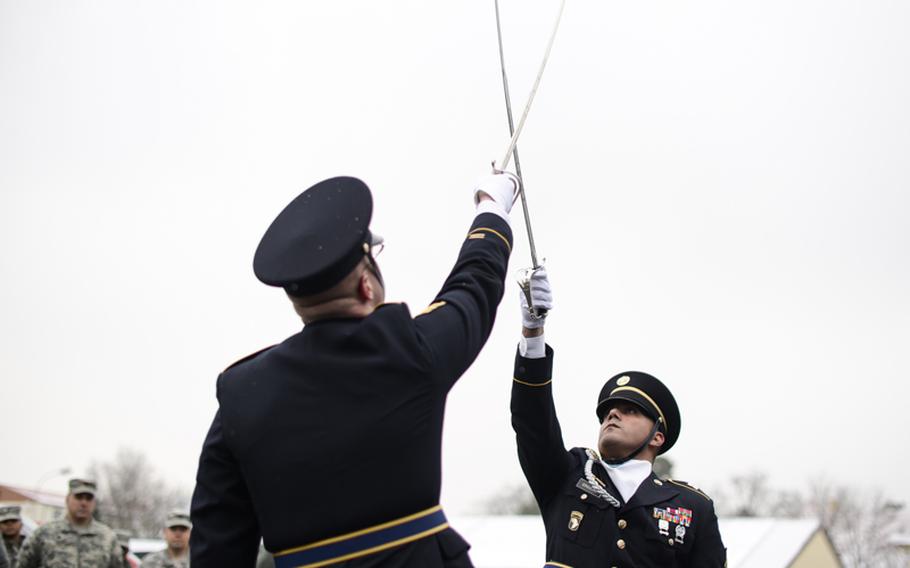 U.S. Army Staff Sgt. Herchel Skinner, left, and Staff Sgt. Jose Graulau, members of the 21st Theater Sustainment Command color guard saber team, perform at the ribbon cutting ceremony for the Wounded Heroes Service Center on Kleber Kaserne in Kaiserslautern, Germany, on Wednesday, Jan. 16, 2013.