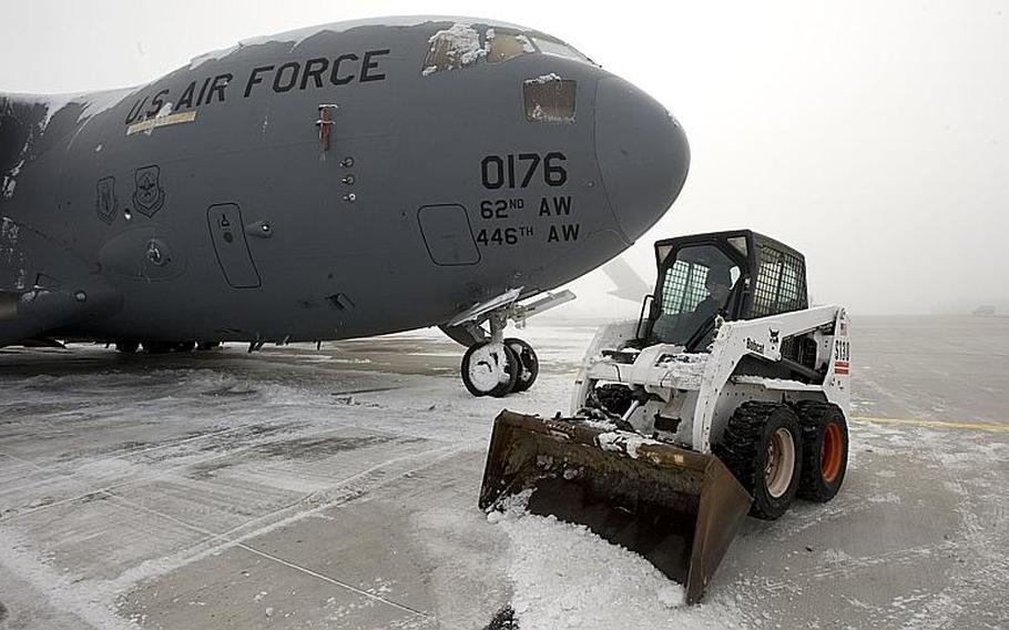 Staff Sgt. David MacGregor, the 728th Air Mobility Squadron-Operating Location Alpha crew chief, clears snow away from a C-17 Globemaster III at Manas air base, Kyrgyzstan, in November 2012. The top U.S. diplomat for South and Central Asian affairs was in Kyrgyzstan on Wednesday, Jan. 16, 2013, as part of an effort to extend the operational lease at Manas.
  
Stephanie Rubi/Courtesy U.S. Air Force