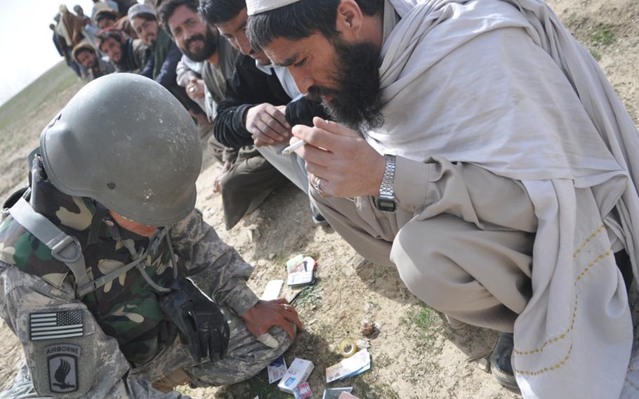 An interpreter working for the U.S. Army interviews villagers in Logar province in 2010. Many translators who worked for American forces now fear for their life because of their affiliation and are frustrated with delays in getting visas to the U.S.