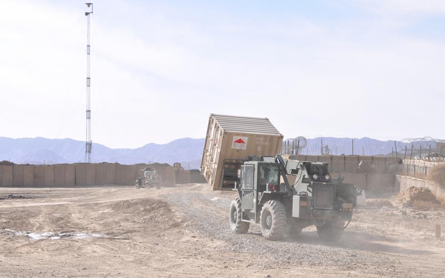 A loader moves items from the U.S. side of the Forward Operating Base Sweeney to the Afghan side. The Afghan National Army, which shares a small corner of the base with U.S. troops, will take over the base when U.S. troops move out. 