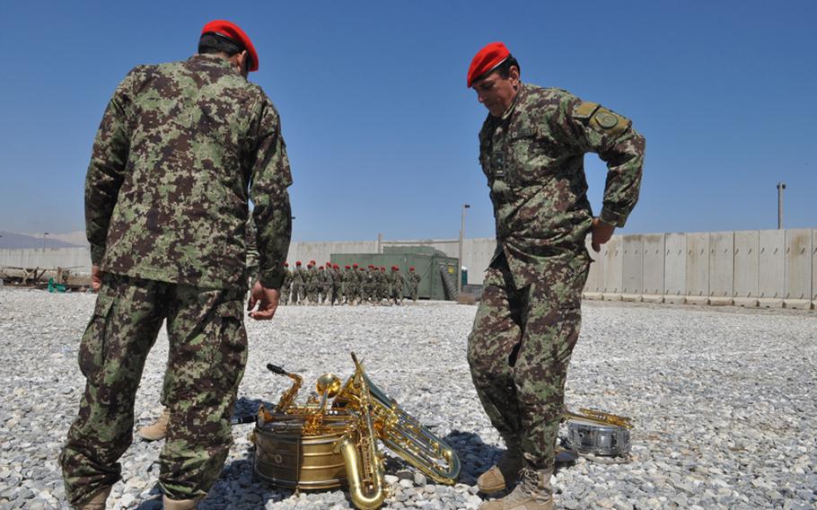 Members of an Afghan military band wait for the start of a ceremony Monday to mark the handover of Parwan Prison at Bagram Airfield from U.S. to Afghan control. Delays in the handover have raised tensions between Washington and Kabul.
