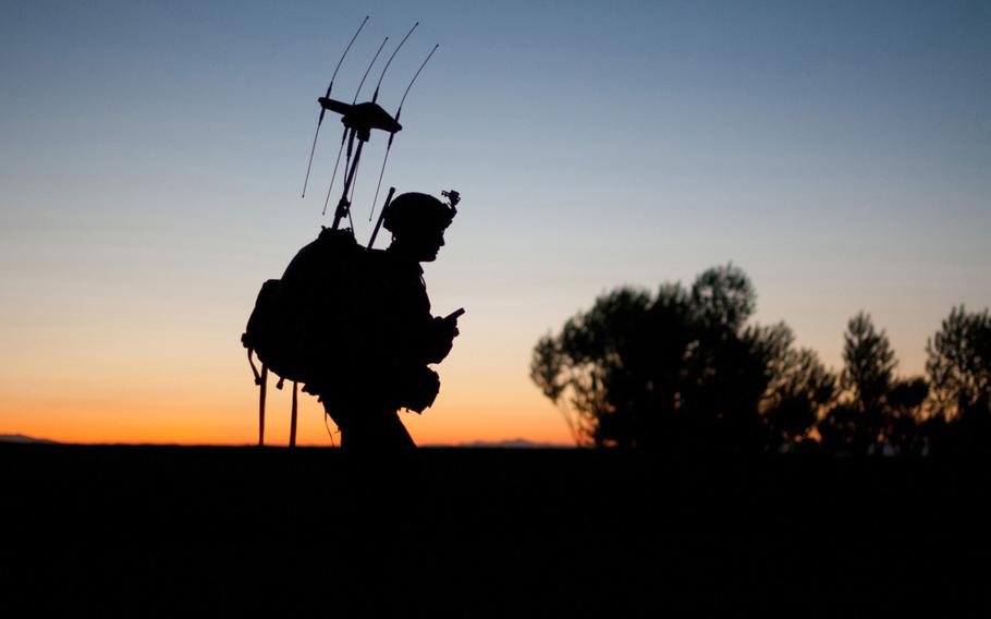 A paratrooper with the 82nd Airborne Division??s 1st Brigade Combat Team passes before the rising sun during a patrol into a village May 4, 2012, Ghazni Province, Afghanistan.  The equipment on his back is used to block remotely detonated improvised explosive devices.
