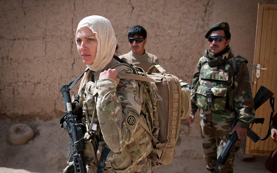 Pfc. Kristina Batty, a medic with the 82nd Airborne Division??s 1st Brigade Combat Team, dons a headscarf to meet with female Afghan villagers May 5, 2012, Ghazni Province, Afghanistan.