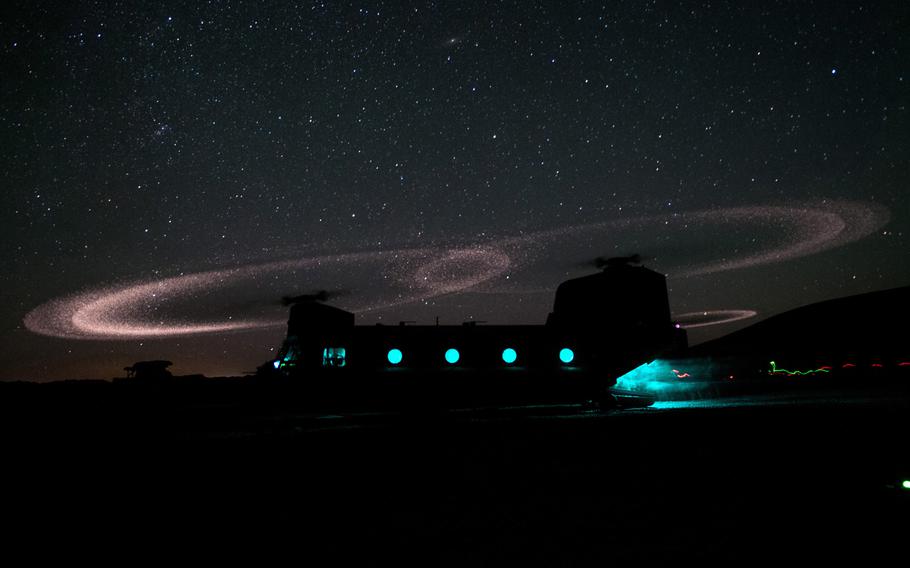 Dust lights up the rotors of a CH-47 Chinook helicopter as paratroopers with 3rd Squadron, 73rd Cavalry Regiment load for an air-assault mission near Combat Outpost Ab Band May 23, 2012, Ghazni Province, Afghanistan.