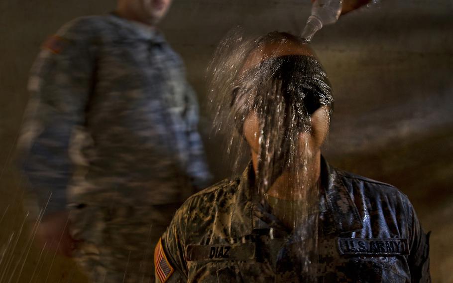 U.S. Army Sgt. Fernando Diaz, a combat medic assigned to 568th Medical Company, Camp Humphreys, South  Korea, is blindfolded and has ice cold water dumped over his head during a mock interrogation as part of the 2012 Pacific Regional Medical Command Best Medic Competition Aug. 30, 2012, at Schofield Barracks, in Wahiawa, Hawaii.
