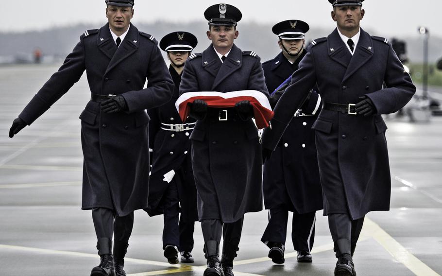 Polish and U.S. Air Force honor guard march to the flag poles during the Aviation Detachment Ceremony, Lask Air Base, Lask, Poland, on Nov. 9, 2012.