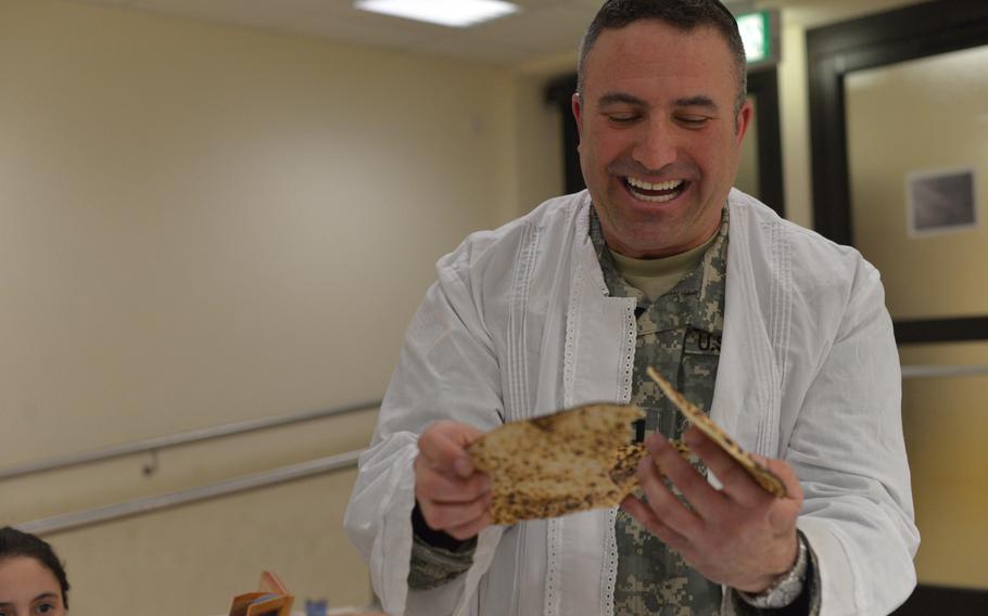 Capt. Andrew Shulman breaks a piece of matza during Monday's Passover Seder in Grafenwohr, Germany. Shulman, U.S. Army Europe's only Jewish chaplain, is hosting four Seders during the holiday.