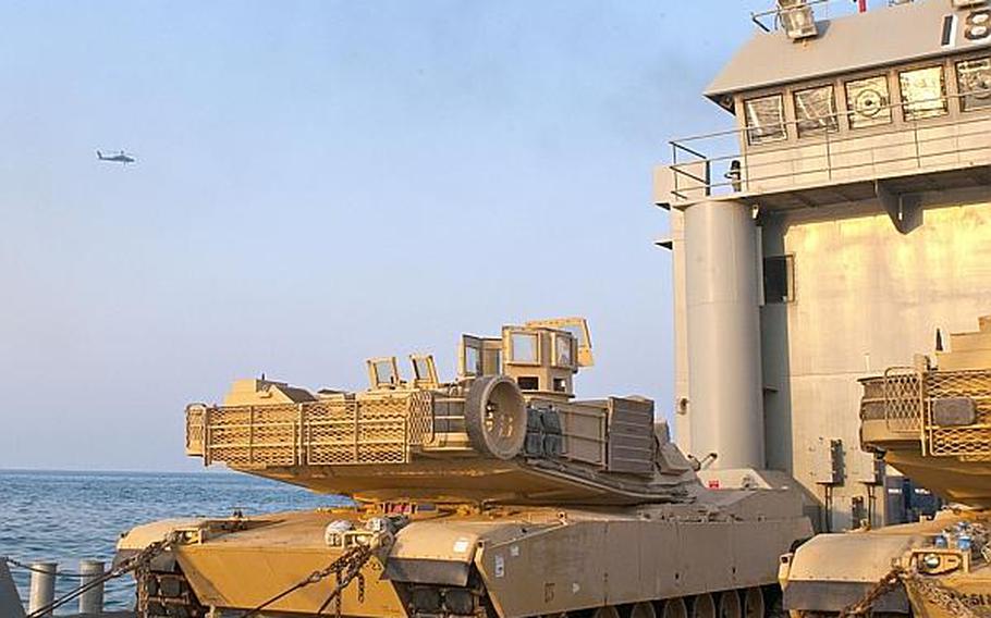 420th Movement Control Battalion's vessel, Landing Craft Utility (LCU) 2018, Five Forks, and its cargo, two M1A2 Abrams main battle tanks during a communication and integration exercise in the Persian Gulf, Oct. 24.