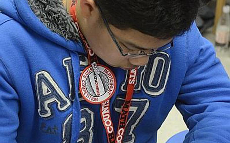 Spangdahlem Middle School's Josher Quevedo, an eighth-grader, works to solve early round math problems at the state MATHCOUNTS competition for Department of Defense Dependents Schools in Europe and the Pacific. The competition was held in Wiesbaden, Germany on March 28, 2013.
