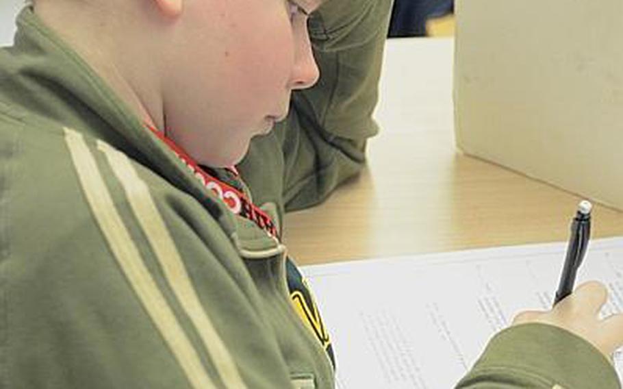Matthew O'Connor, a seventh-grader at SHAPE, works to solve a math problem during a MATHCOUNTS state competition March 28, 2013, in Wiesbaden, Germany. O'Connor, along with teammates Caleb Bavlnka, Samantha Diwa and Lizzie Hobbs, captured the overall team title at the event. SHAPE is coached by Gale Cannon.