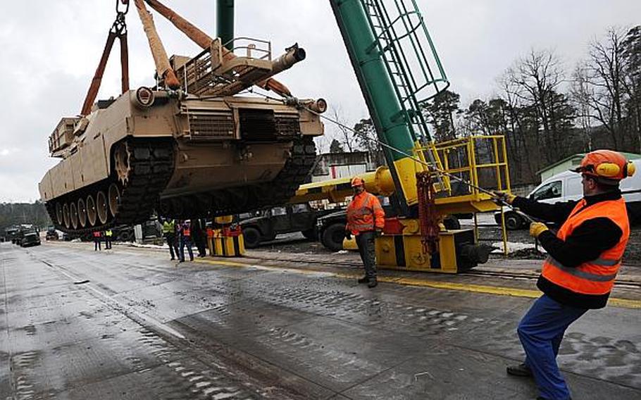 German railway loadmasters with the Theater Logistics Support Center Europe help load an Abrams main battle tank at the railhead in Kaisersalutern. The tank was one of 22 bound for South Carolina, marking the end of an Army tank presence in Germany.