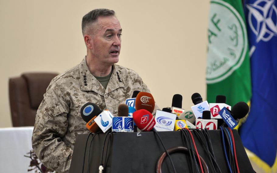 Gen. Joseph Dunford, commander of the NATO-led international military force in Afghanistan, speaks at Bagram Airfield in Afghanistan during a March ceremony marking the handover of a prison from American to Afghan control. As the war has dragged on and with the deadline for international combat troops to leave looming, commanders and public affairs officers have painted an increasingly positive picture of Afghanistan, even as fighting has continued unabated and an entrenched insurgency shows no signs of giving up.