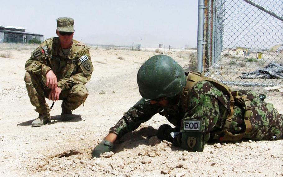 Afghan Lt. Omed Khan looks for signs of a bomb during a training course at Forward Operating Base Eagle in Zabul province, Afghanistan in April. Khan's unit was training under the U.S. Army's 162nd Explosive Ordnance Company, 3rd Ordnance Battalion, once a week since December of last year in preparation to take over control of such missions in Zabul after coalition troops leave Afghanistan in 2014. Khan is an explosive ordnance disposal team leader with the 2nd Brigade, 205th Core, Route Clearance Company of the Afghan National Army.