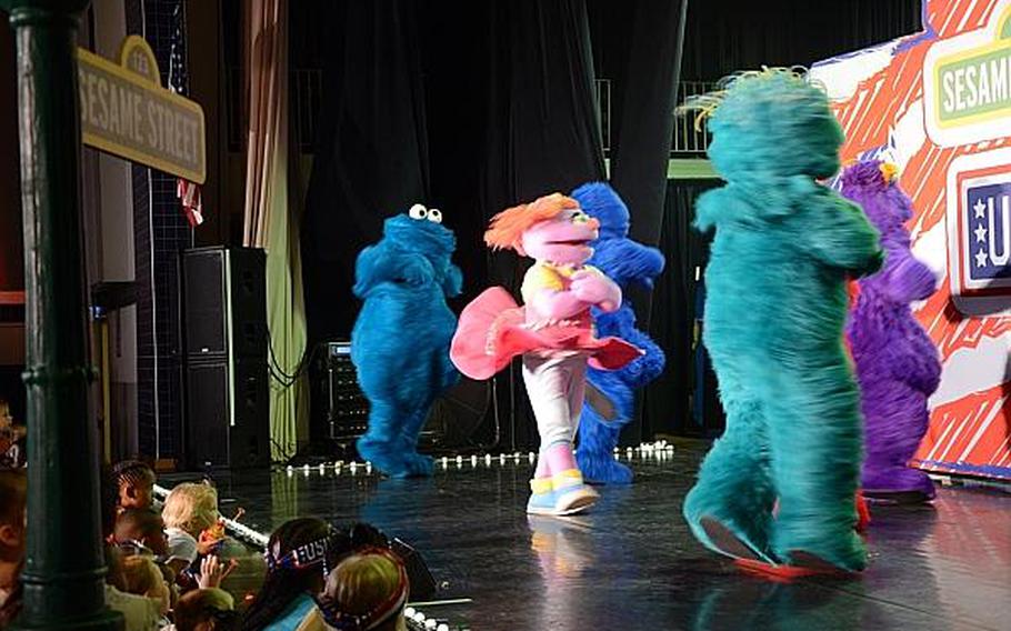 Children crowd the stage as "Sesame Street" characters dance and sing at a show Friday, July 5, 2013 at Aviano Air Base, Italy.

Jason Duhr/Stars and Stripes