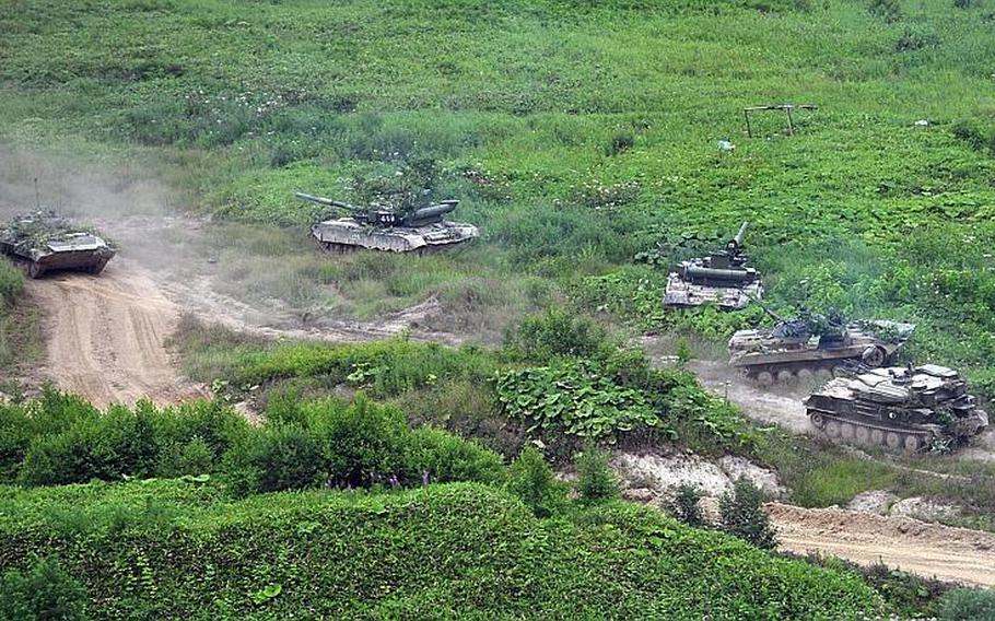 Russian army tanks move on Sakhalin Island during military exercises seen in this file photo from Tuesday, July 16, 2013. The massive exercises, held in Siberia and the far eastern region involved 160,000 troops and about 5,000 tanks.