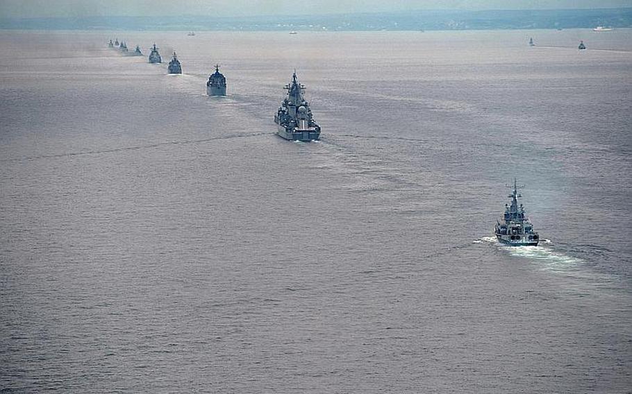 In this file photo from Tuesday, July 16, 2013, Russian navy ships sail near Sakhalin Island, in the north Pacific Ocean, during military exercises. The maneuvers in Siberia and the far eastern region of Russia involved 160,000 troops and about 5,000 tanks. 
