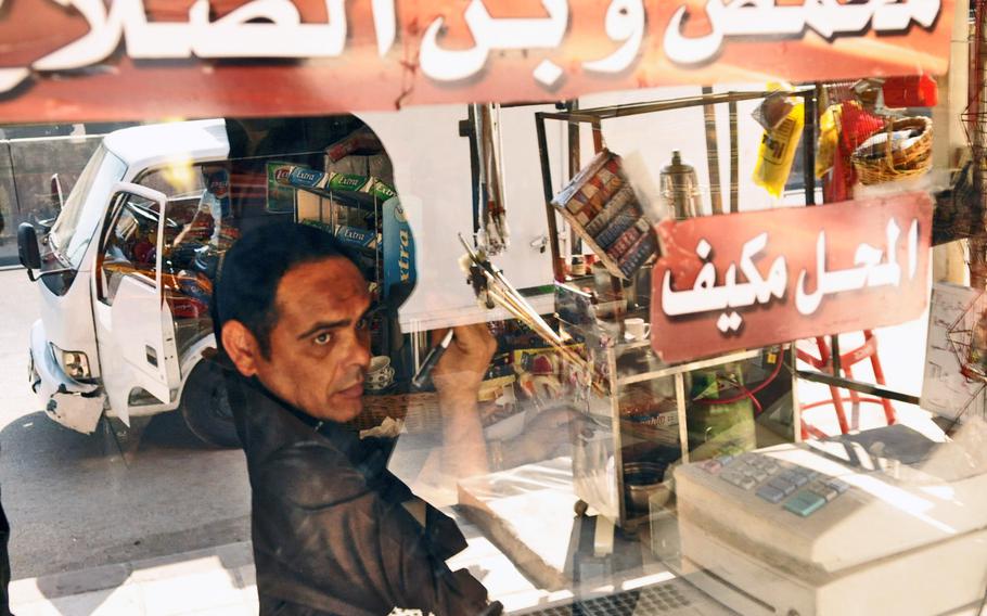 A Palestinian man inside his shop in the Baqa'a refugee camp in Jordan.