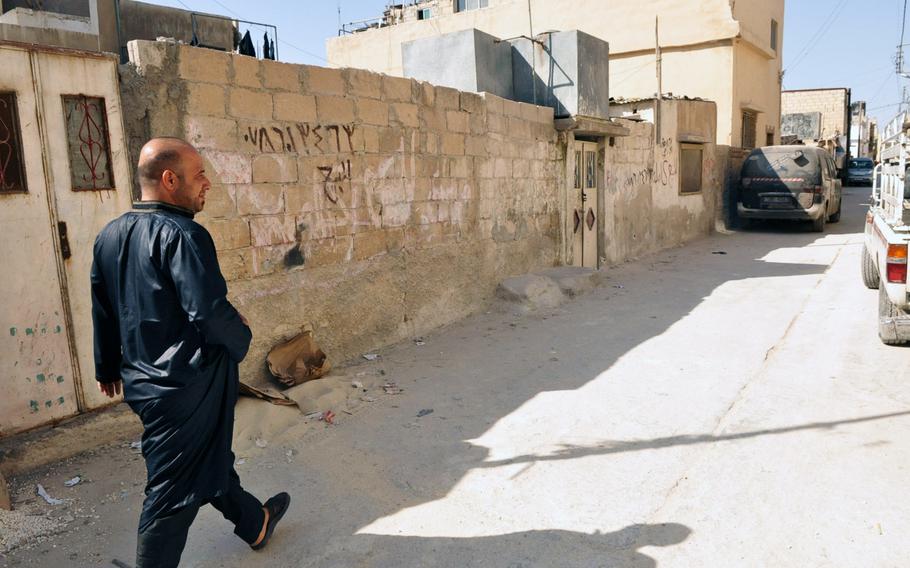 Muhammad Halaweh, a Palestinian by descent, walks down a street in the Baqa'a refugee camp near Amman Jordan.Halaweh said he worries that Syrian refugees are becoming the priority for the Jordanian government, and services the Palestinians have always received will eventually be transferred to the Syrians.