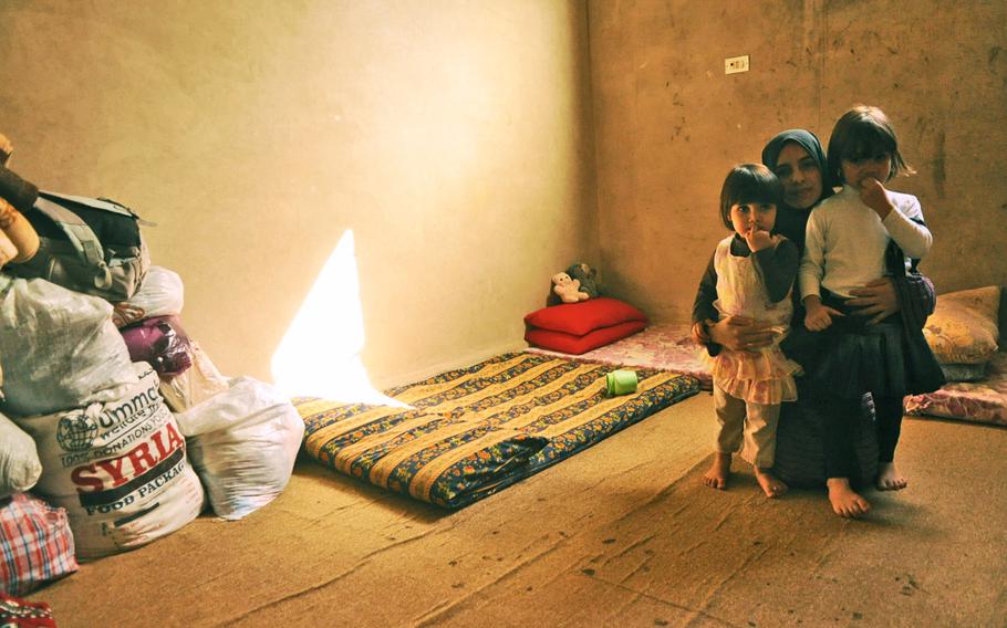 Esmaa Ali Ismira and her daughters have moved into a room at the Baqa'a Palestinian refugee camp in Jordan. Ismira is a Syrian refugee who moved into the camp 1 1/2 years ago when her family fled their home country because of the ongoing civil war. Her family is one of the growing number of Syrian refugees who have managed to move into the more established refugee camps, which were originally designed to house Palestinians.