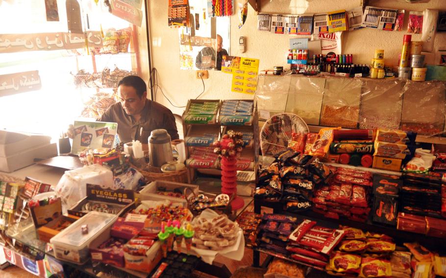 A Palestinian man inside his shop in the Baqa'a refugee camp near Amman, Jordan. Palestinian refugees living in Jordan fear that resources that had been devoted to their camp will eventually all be shifted to support the large influx of Syrian refugees in the country that are fleeing fighting in their home country.