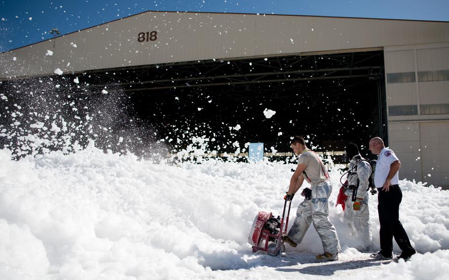 A small sea of fire retardant foam was unintentionally released in an aircraft hangar, temporarily covering a small portion of the flight line at Travis AFB, Calif., Sept. 24, 2013. The non-hazardous foam is similar to dish soap, and eventually dissolved into liquid, which was helped by high winds. The 60th Air Mobility Wing firefighters helped control the dispersion by using powerful fans and covering drains.