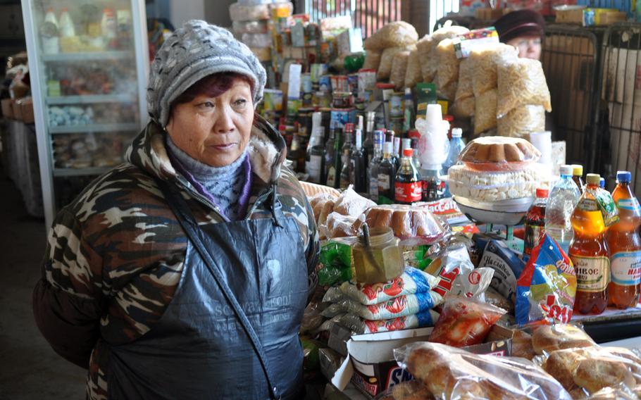 Karachach Iskazhaeva, a shopkeeper at a market in rural Kyrgyzstan, says she's more worried about the loss of jobs when the nearby American Air Force base closes than she is about pollution or other problems that have marked its existence.