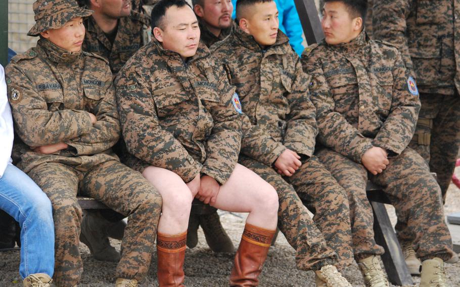 A Mongolian soldier waits on the sidelines for his turn to wrestle in the annual Lunar New Year wrestling match at Camp Marmal, Mazar-e-Sharif, Afghanistan, Jan. 31, 2014.