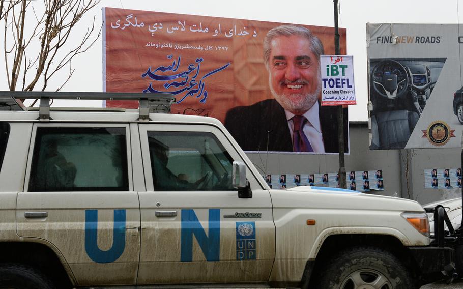 A grinning Abdullah Abdullah graces a billboard in Kabul advertizing his candidacy for the Afghan presidency. The billboards and posters were put up on Sunday, Feb. 2, 2014, as candidates were officially allowed to begin campaigning.