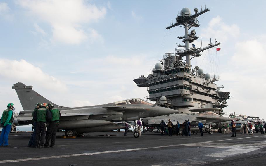 Two F1 Rafales, attached to the French aircraft carrier Charles de Gaulle, refuel on the flight deck of the aircraft carrier USS Harry S. Truman during carrier qualification integration Jan. 13, 2014, in the Persian Gulf.  
