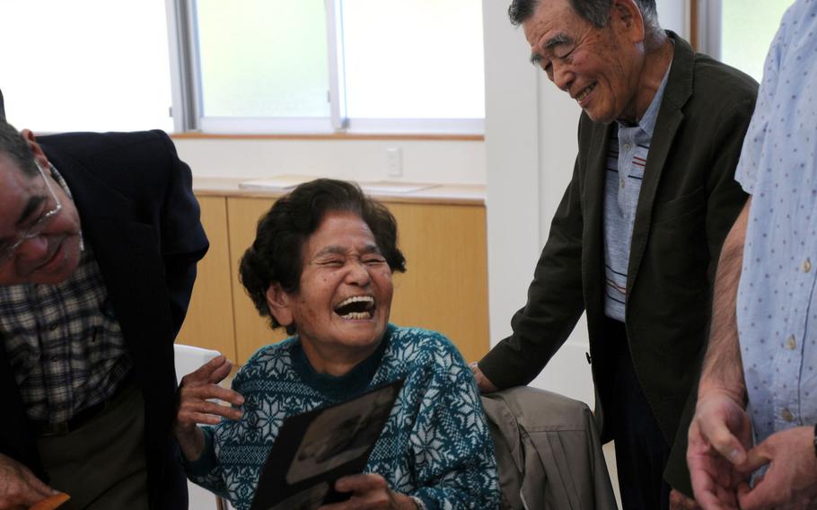 Masako '''Iha''' Sunabe shares a laugh with family and former Irei Association members after seeing her sister's photo album for the first time in nearly 70 years in Chatan, Okinawa, Jan. 12, 2014.
