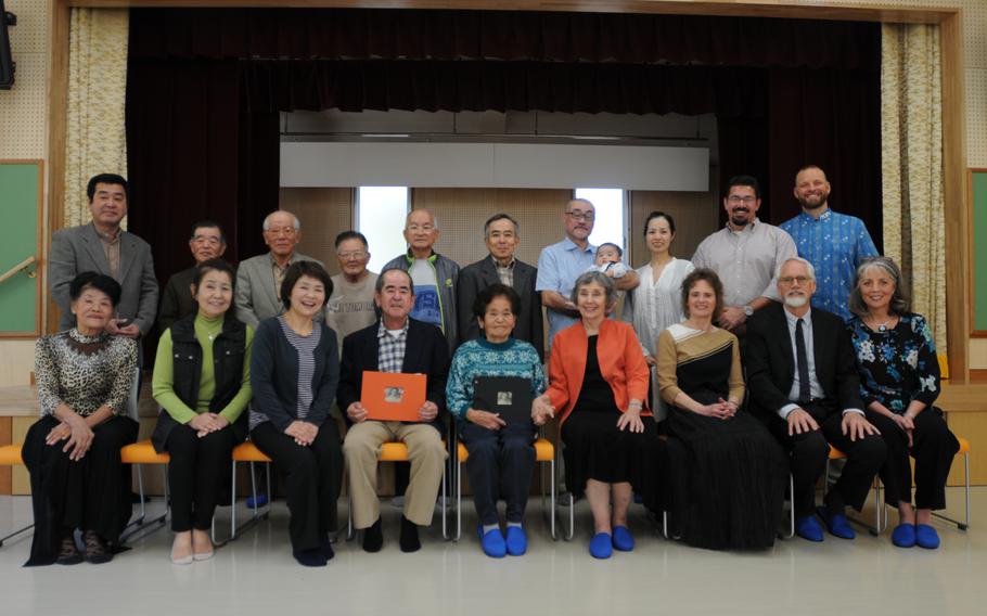 The Sunabe family, formers members and relatives of the Irei Association, and the Wieden clan pose together after the Wiedens formally returned the Sunabe family's photo album in Chatan, Okinawa, Jan. 12, 2014.