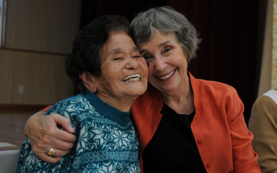Masako ''Iha'' Sunabe and Carolyn Wieden embrace after the Weiden family formally returned Mitsuko Sunabe's photo album in Chatan, Okinawa, Jan. 12, 2014.