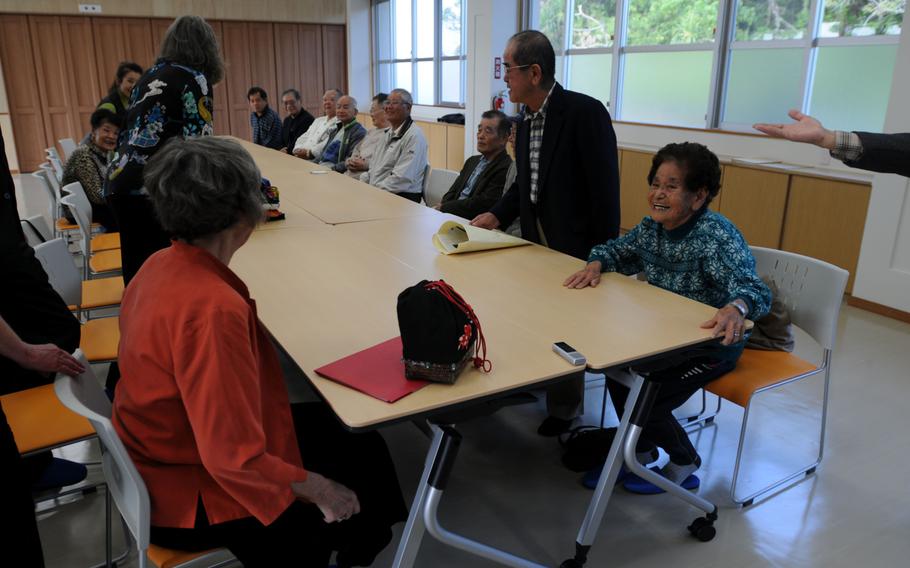 The Wieden family sits down with the Sunabe family, as well as relatives and former members of the Irei Association, before a formal ceremony to return the Sunabe family's photo album in Chatan, Okinawa, Jan. 12, 2014.