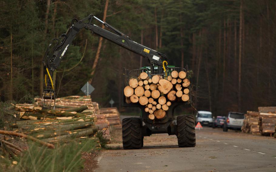 A picker stacks logs on the side of the road on Tuesday, Feb. 4, 2014, at Rhine Ordnance Barracks in Kaiserslautern, Germany, where the groundwork for a new $990 million military hospital got underway Monday.