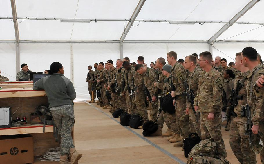 Soldiers from the 2nd Brigade Combat Team, 101st Airborne Division prepare to check in at the newly constructed passenger holding area at  Mihail Kogalniceanu Air Base in Romania on Feb. 2, 2014. 