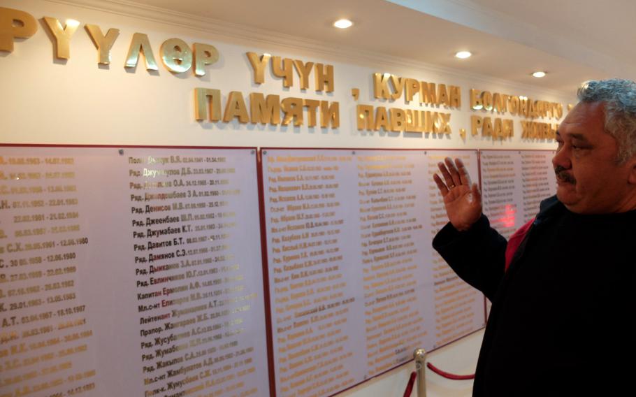 Soviet army veteran Hidar Dyikanbaev points out a wall with the names of fellow soldiers from Kyrgyzstan who died fighting for the Soviet Union in Afghanistan. The wall is located at the headquarters of Kyryzstan's council for veterans of the Afghan War.
