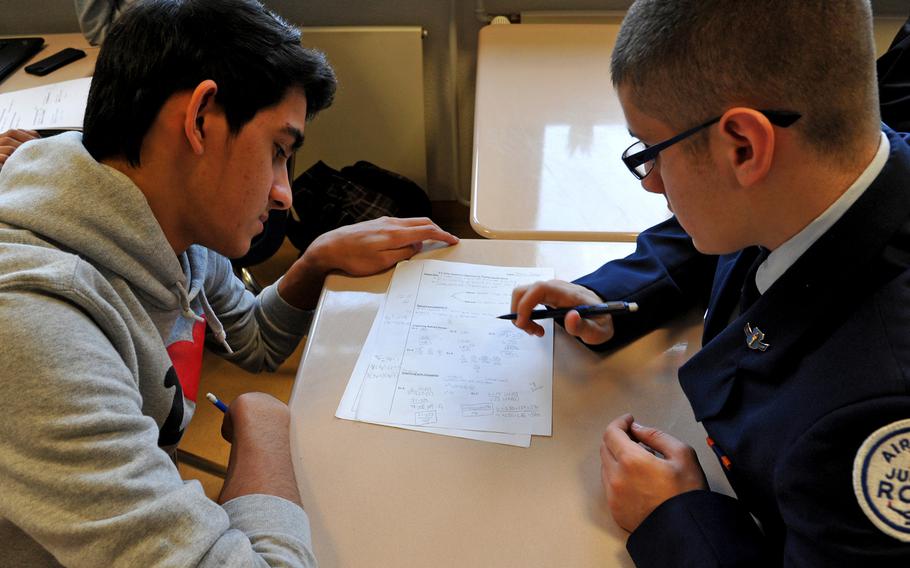 Aaron Brewer, left, and Marco Tartaglio discuss a problem during a recent "flipped mastery" algebra class. Both are juniors at Ramstein High School in Germany.