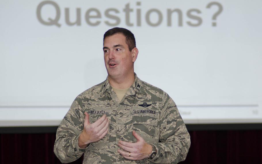 Col. Mark August, 374th Airlift Wing commander, answers questions about force reduction at the Airman Readiness Center at Yokota Air Base, Japan, on Feb. 12, 2014.