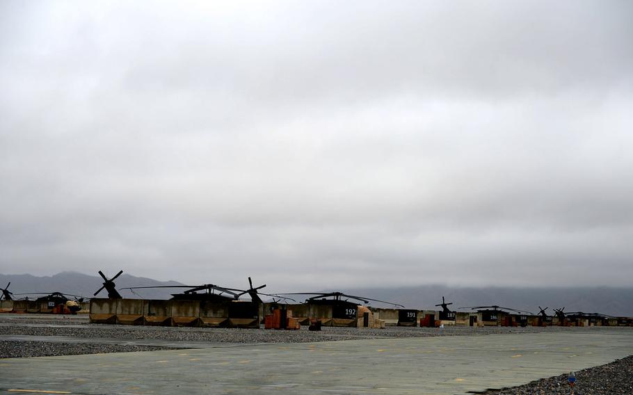 Rows of helicopters at Kandahar Air Field, Afghanistan, were grounded by low-hanging clouds and generally poor weather for a week in early February. Snow is a rare thing in the desert around Kandahar, where temperatures can climb upward of 130 degrees Fahrenheit in the summer.