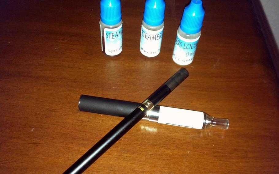 Many electronic cigarettes, or e-cigs, could be mistaken for a pen, while others might be confused for drug paraphernalia. The battery-powered devices, which turn flavored liquids (shown here) into a vapor that is inhaled, have been added to the list of prohibited items at Defense Department schools in Europe and the Pacific.