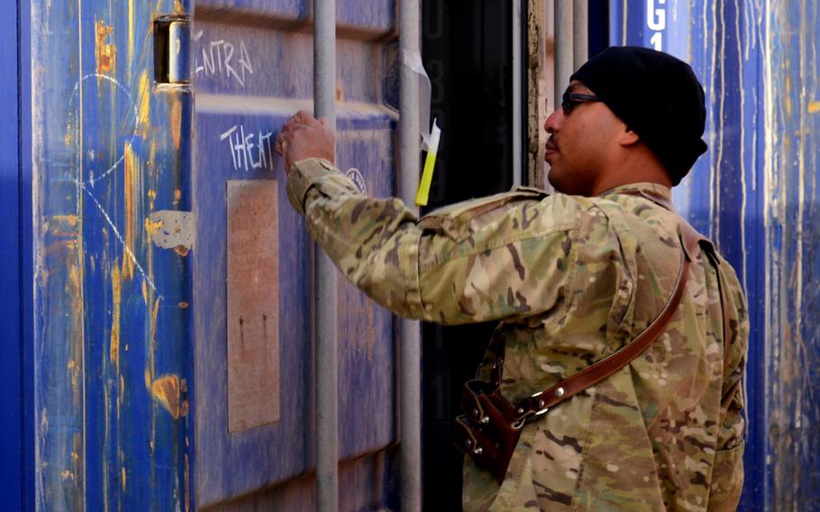 Coast Guard Reserve Petty Officer1st Class Nelson F. Del Valle of Redeployment Assistance and Inspection Detachment Team 13 tags a container after inspection in Helmand province, Afghanistan, in 2011. Members of the Coast Guard team check containers for seaworthiness and structural integrity before sending them back to the United States. 